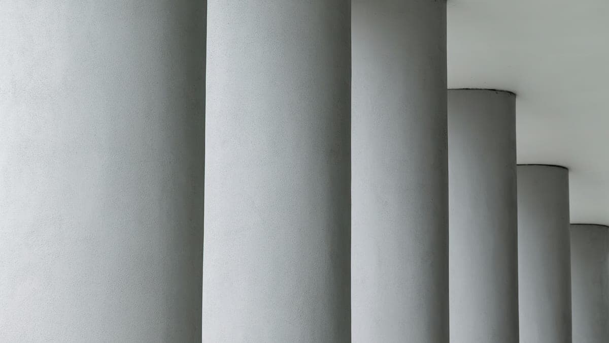 A row of pale round columns receding to the right