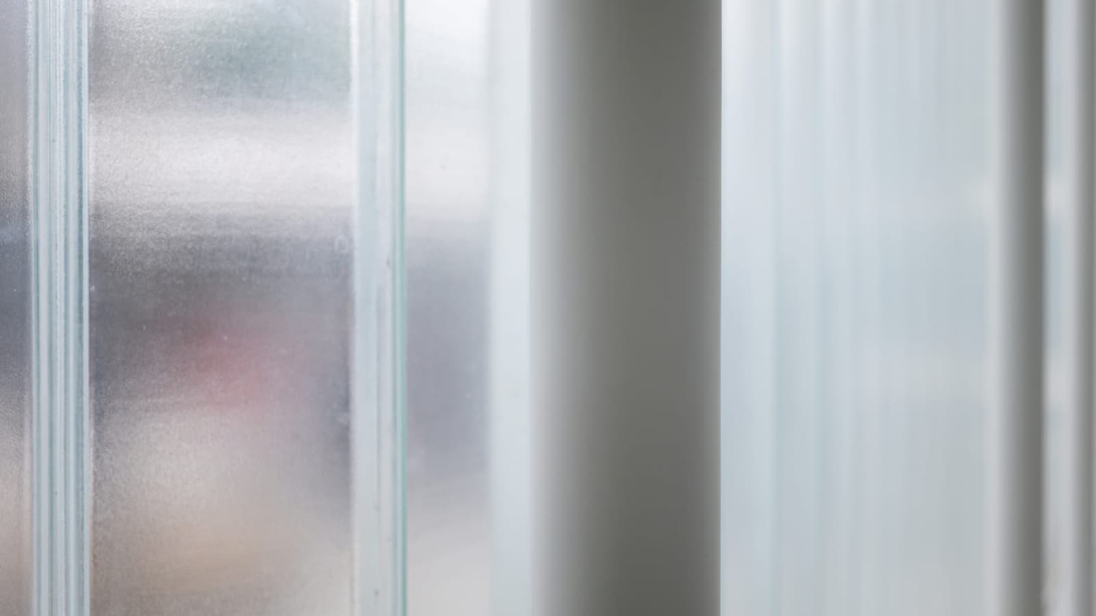 Frosted glass panels with soft daylight behind them