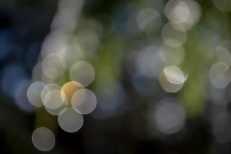 Abstract bokeh lights representing the gap between aggregated reporting and granular analysis